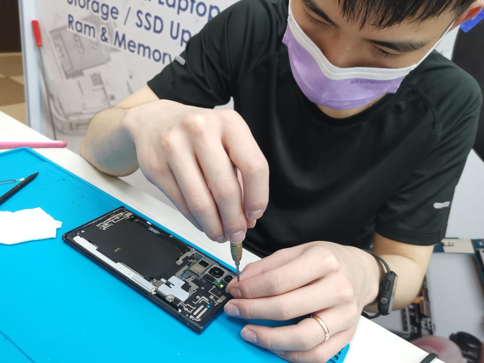 android device being disassembled by phone technician